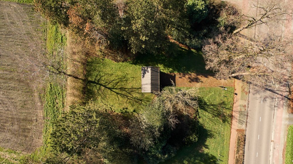 Overview of the property: structure and backyard with underground water reservoir (drone photo)