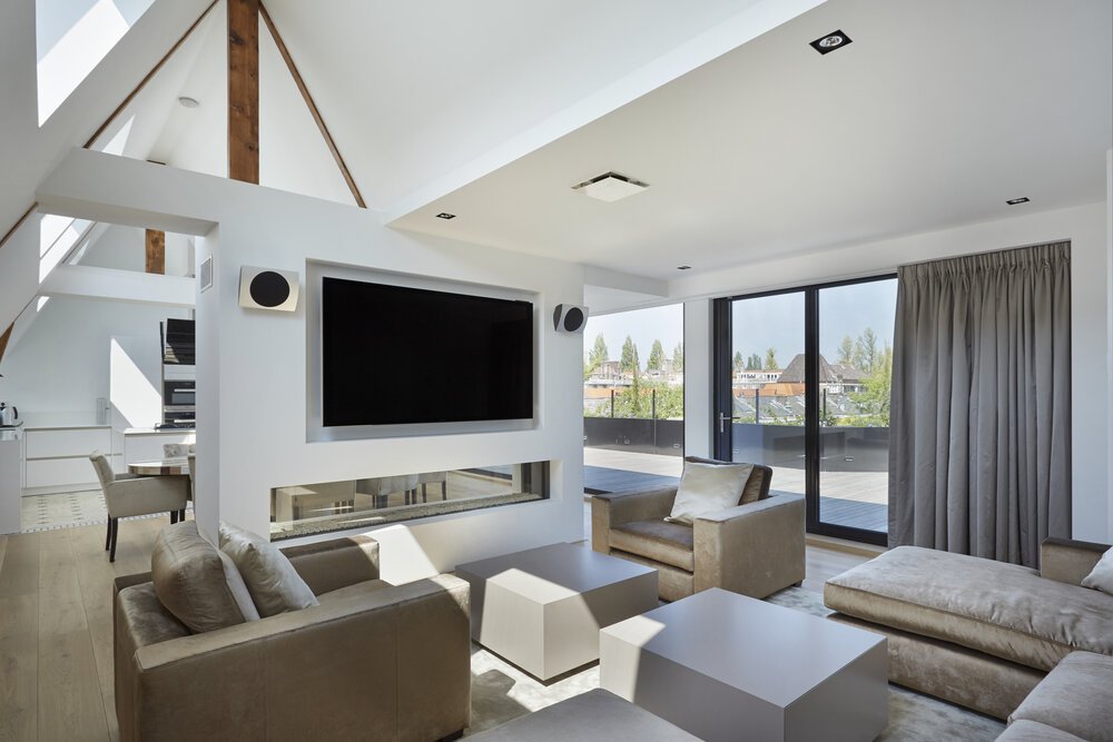 Integrated gas fireplace and television divide the open-plan floor.