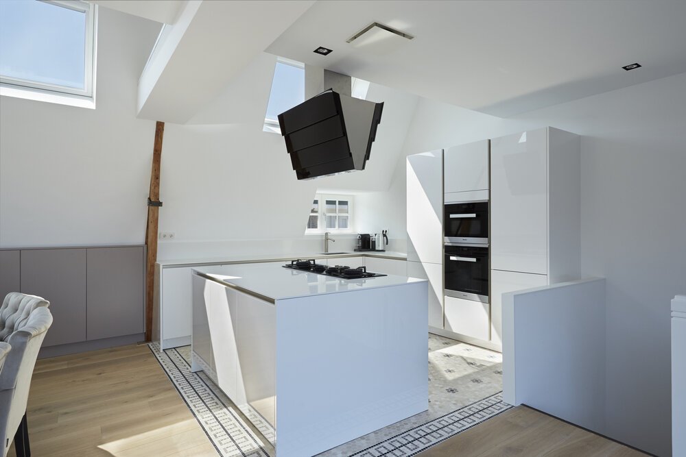 Modern, clean-lined kitchen while preserving the authentic tiles.