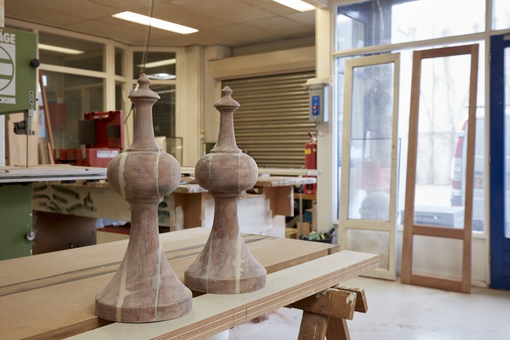 Turned wooden elements are repaired.