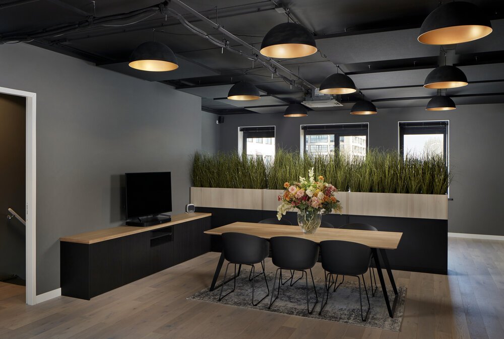 Interior photo showing acoustic ceiling panels above seating and work areas.