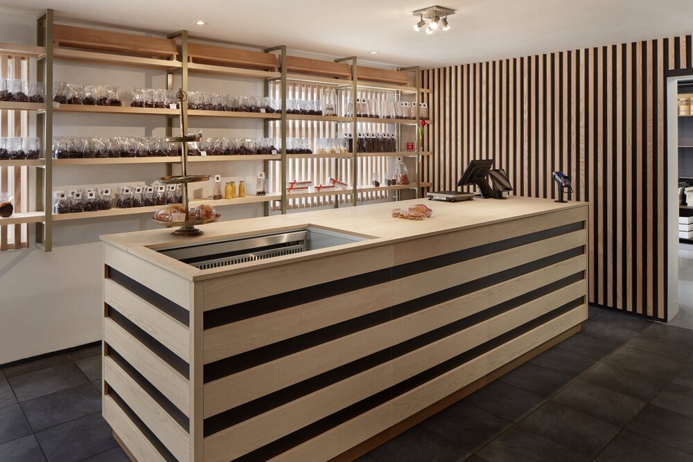 Counter with rear display and wooden wall detailing.