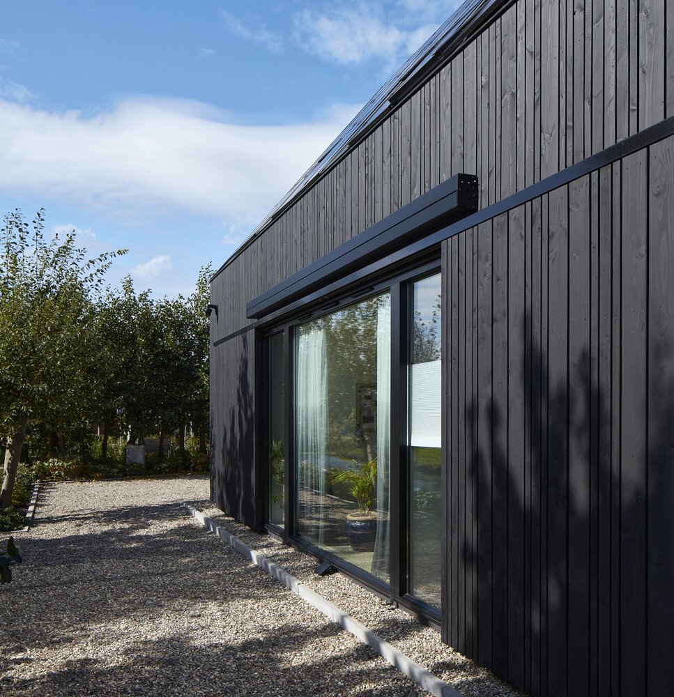 Black wooden slats allow the home to blend seamlessly into the landscape.