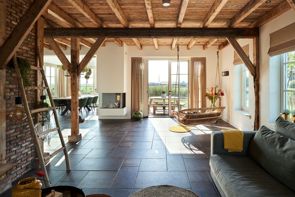 The mix of classic windows, reused materials, and modern plasterwork makes the interior distinctive.