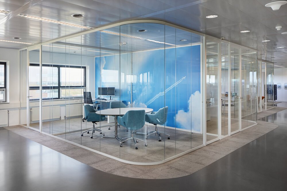 Workstations with curved glass walls.