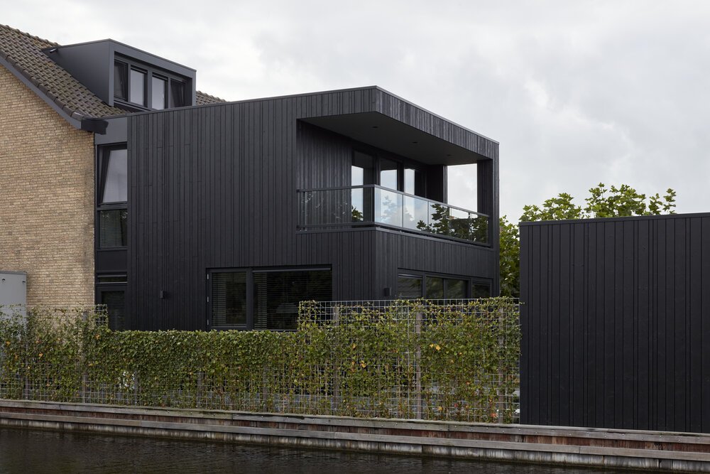 The storage space uses the same timber cladding, creating a cohesive feel in the rear garden.