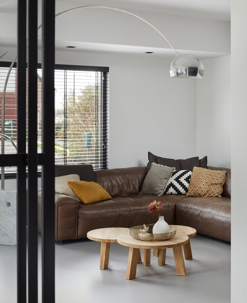 Clean-lined living room with anthracite-grey sliding doors.