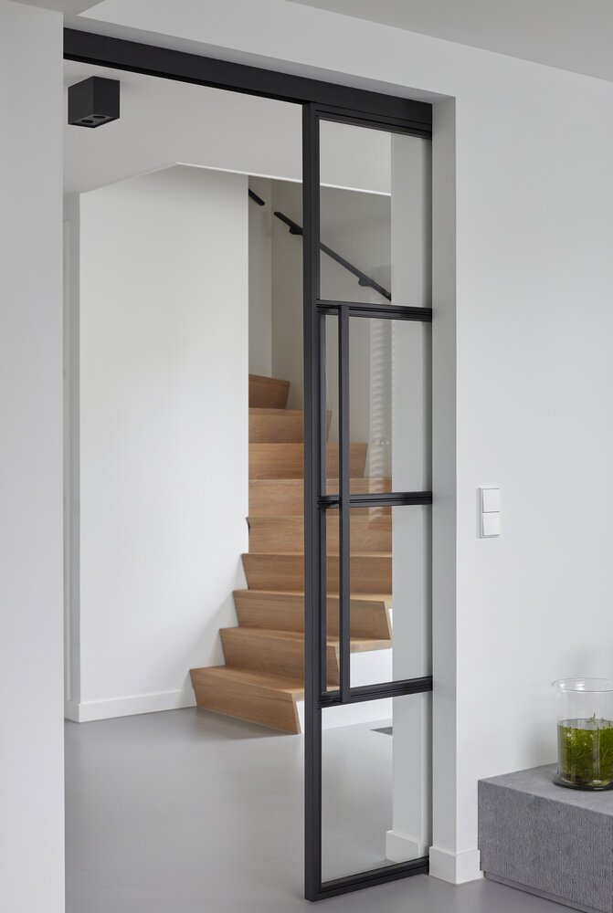 Sliding doors between the living room and the entrance hall.