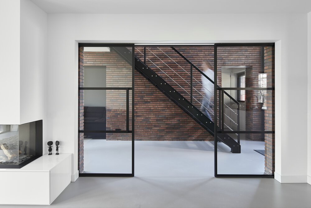 Interior photo showing how the central section creates a sense of space through the use of glass.