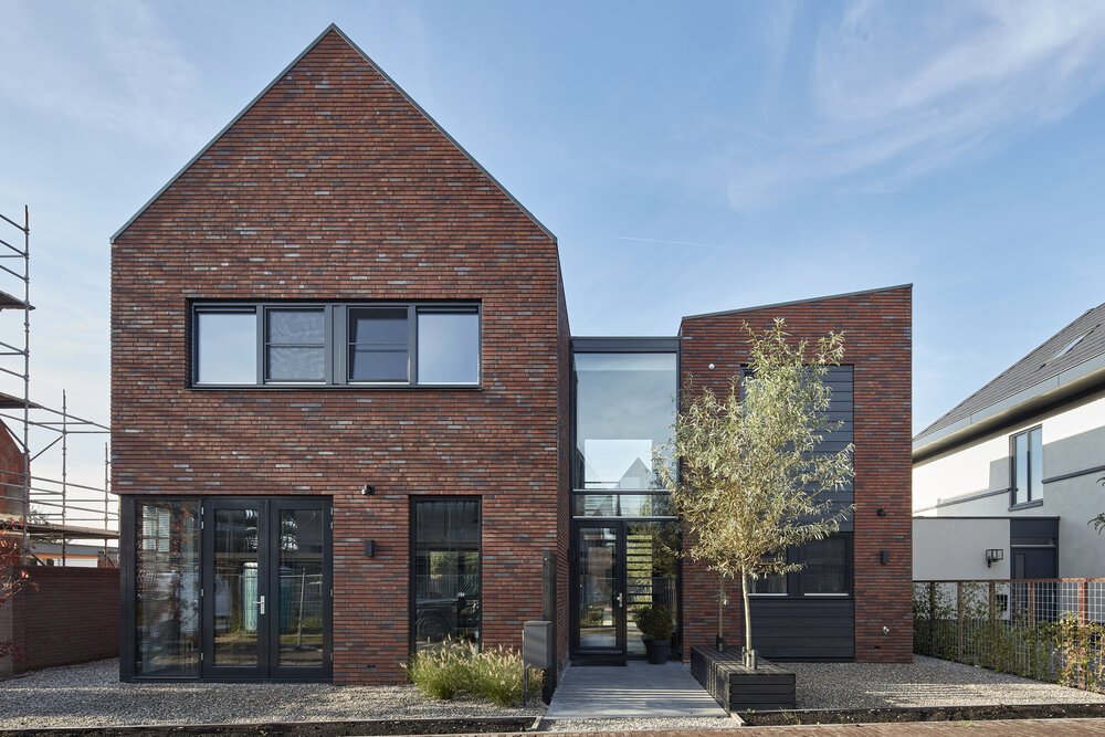 Exterior view of the home featuring the glass central section.