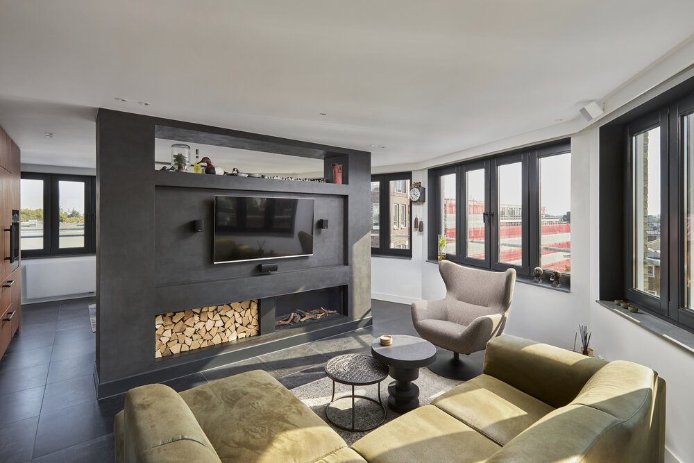 Fireplace and TV unit separating the living room from the kitchen.