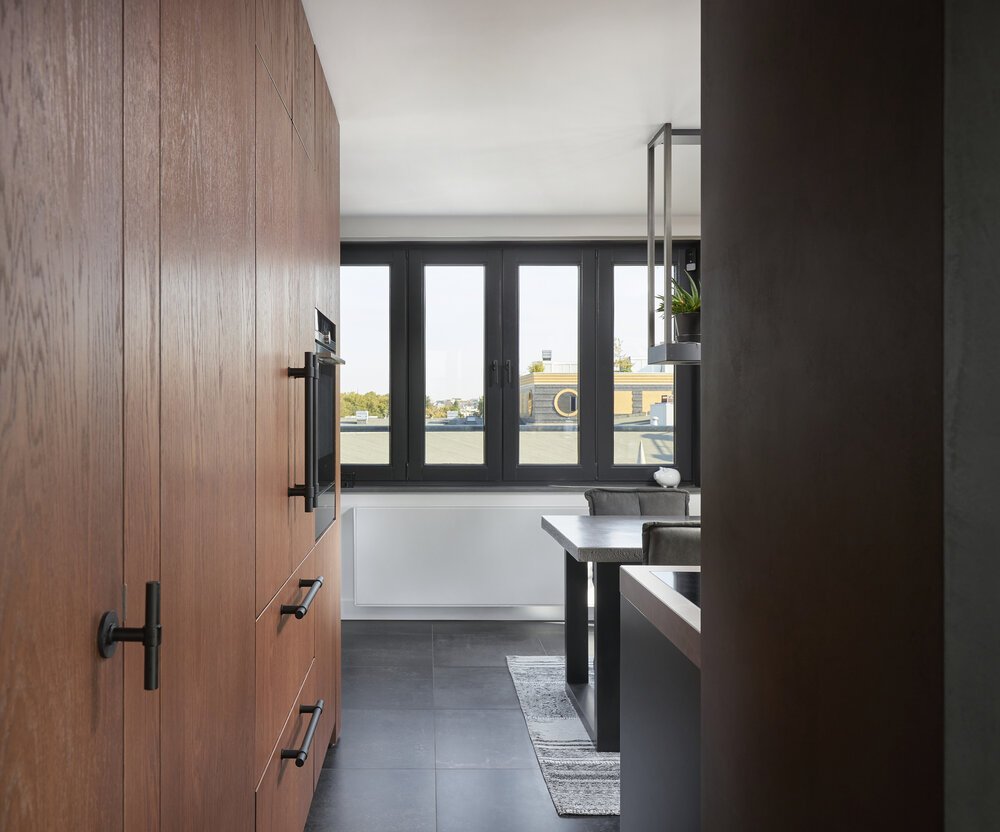 Built-in appliances integrated into the smoked oak wall.