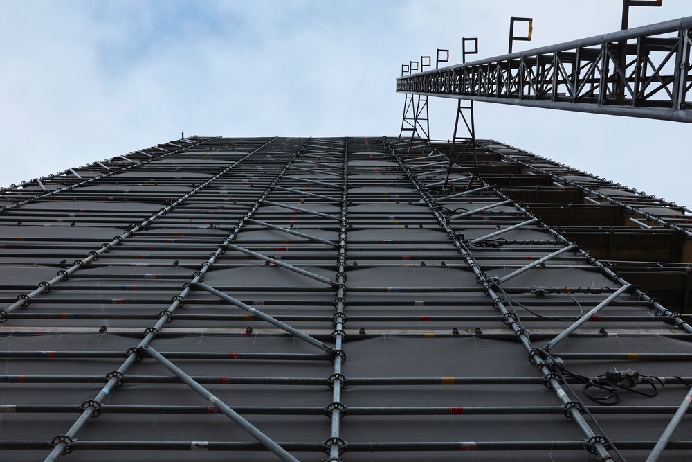Scaffolding for renovation work with safety nets and guardrails.