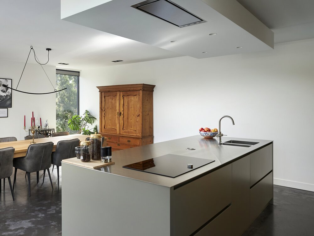 Clean-lined kitchen island with a stainless steel worktop.