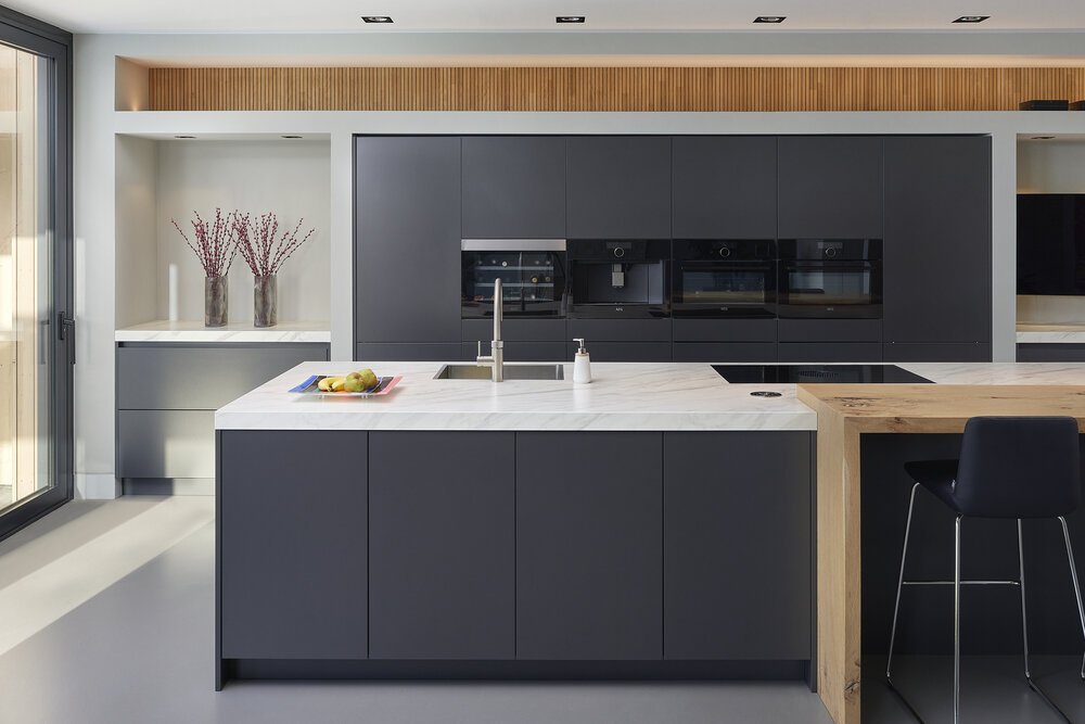 Interior photo of the kitchen with wooden wall cladding.