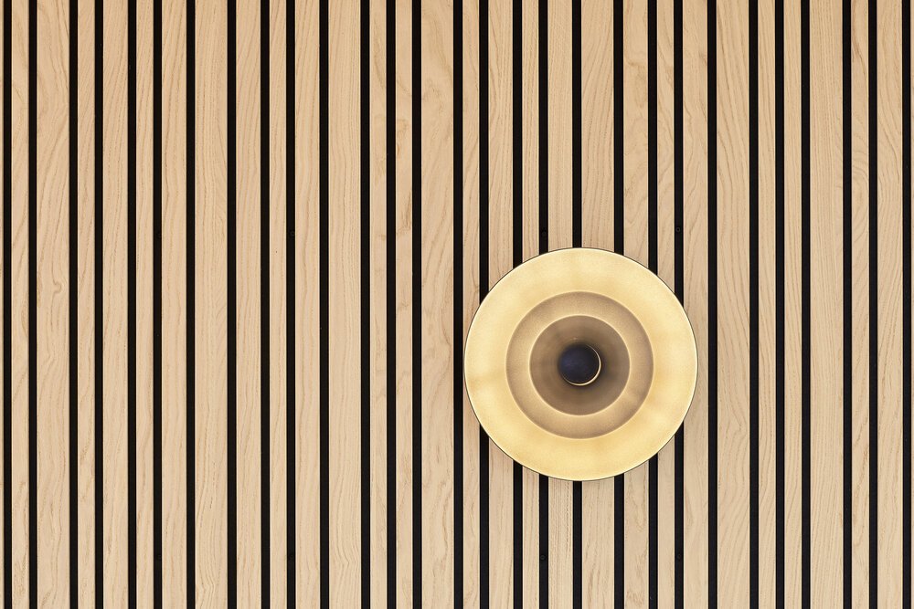 Detail shot featuring wooden wall cladding and lighting.