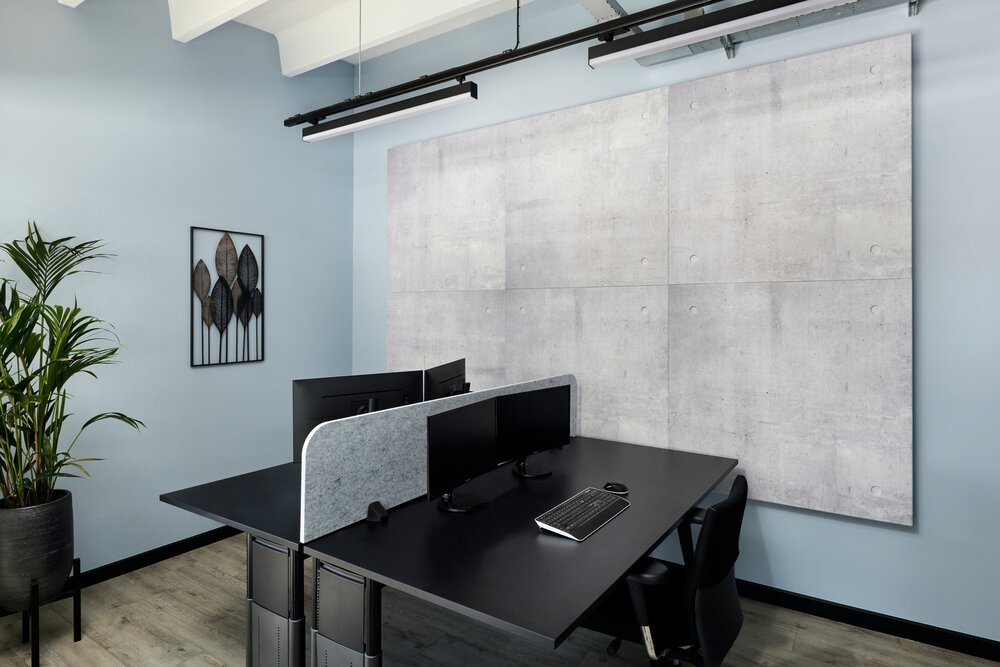 Interior photo of a workspace with acoustic panels mounted on the wall.