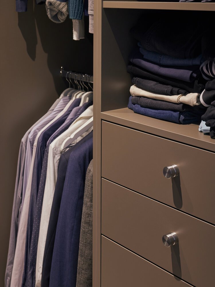 Clothing and accessories neatly organised within the wardrobe.