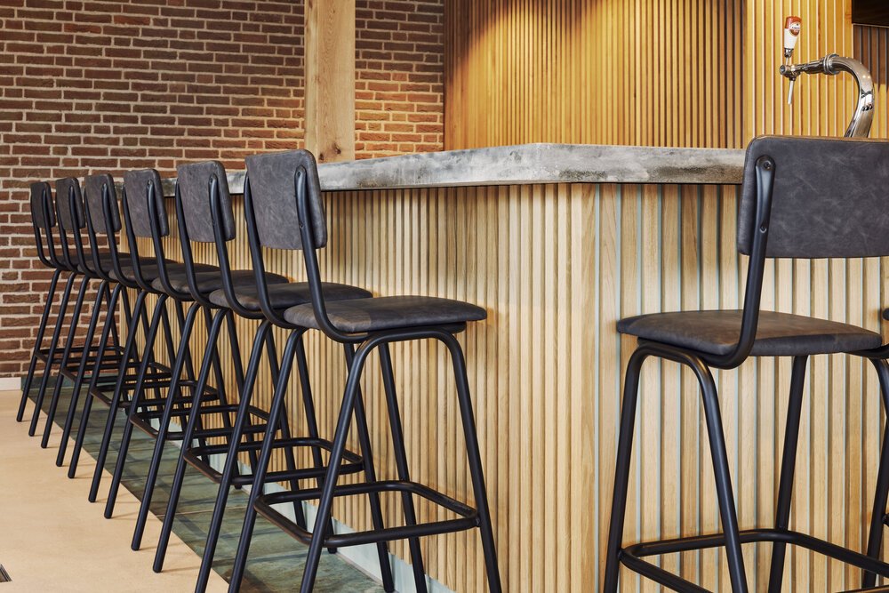 The wooden slats create a warm appearance in combination with the concrete bar top.