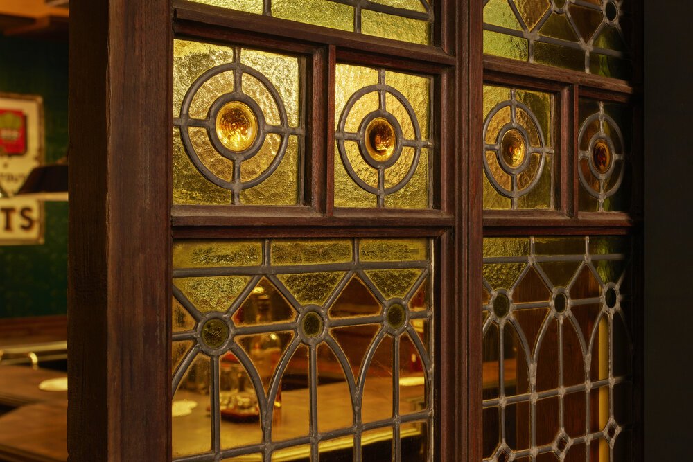 Authentic stained-glass doors reused.