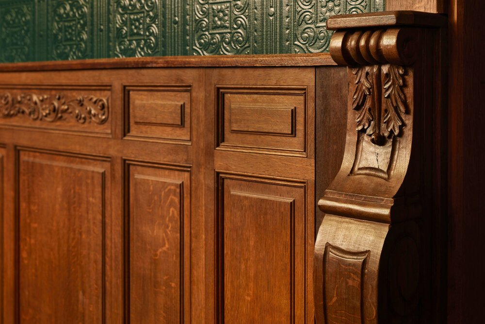 Detail shot of the wallpaper, wainscoting, and reused materials.