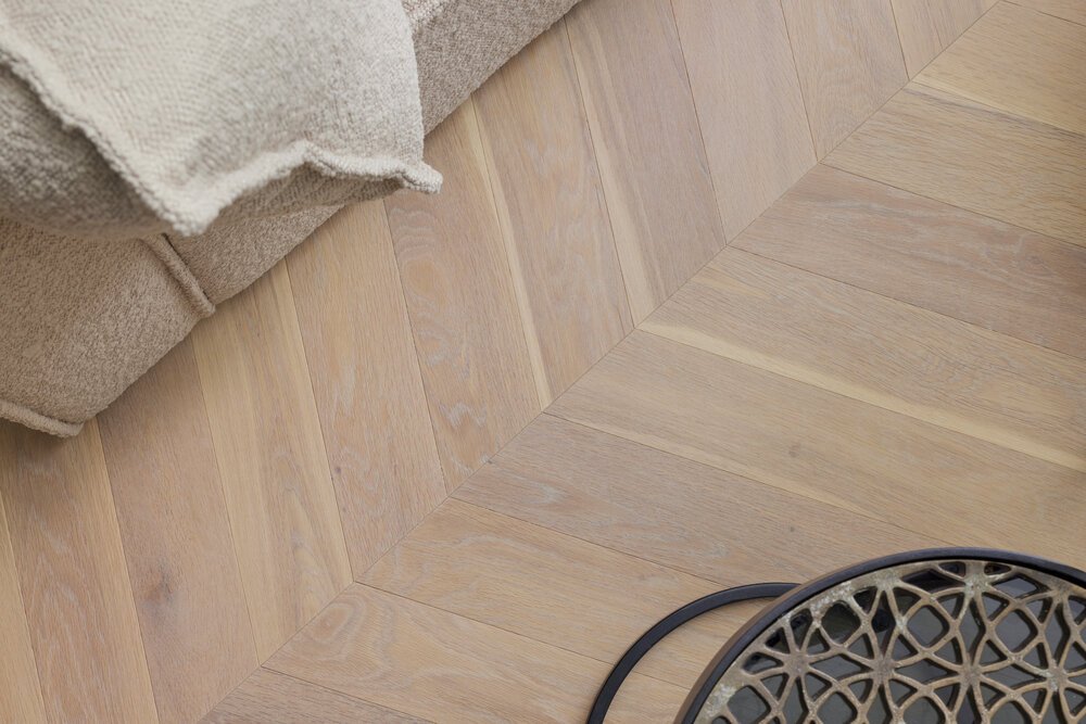 Detail shot of a seating area featuring a Hungarian point pattern.