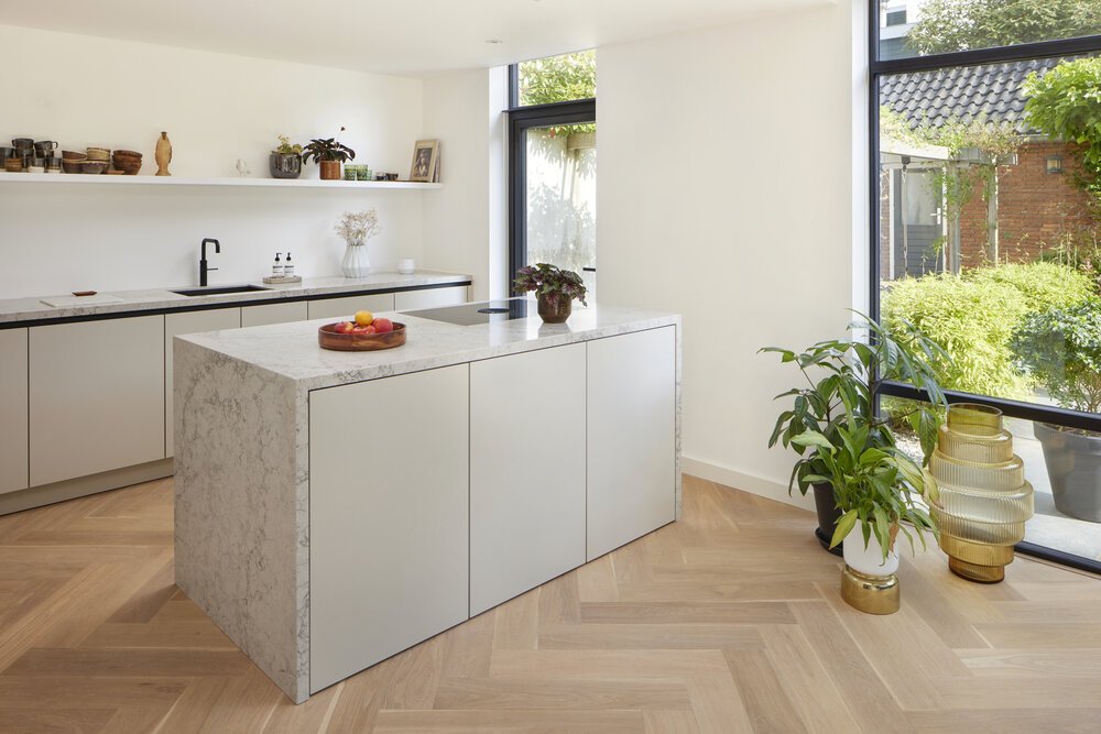 Herringbone flooring with a kitchen island.
