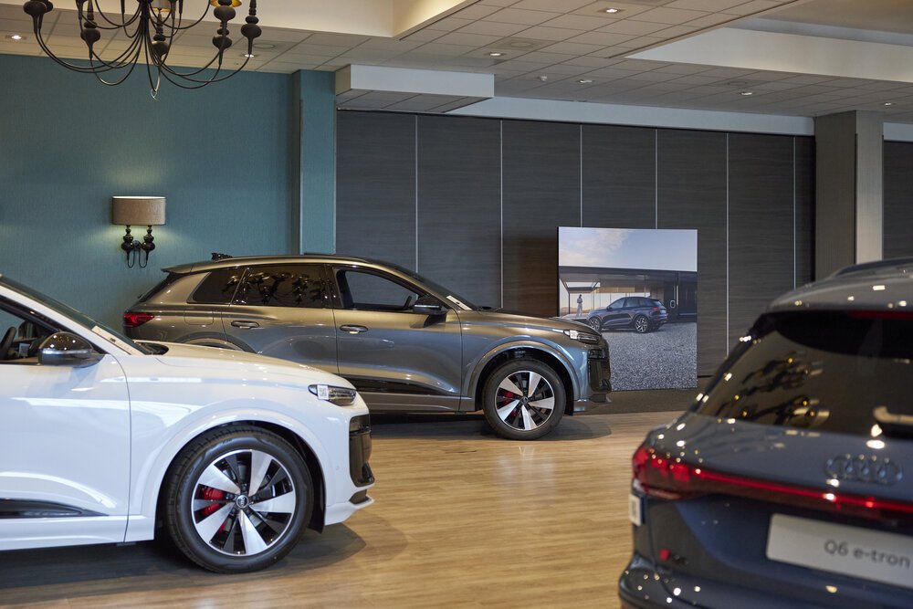 Various versions of the Audi Q6 e-tron displayed side by side.