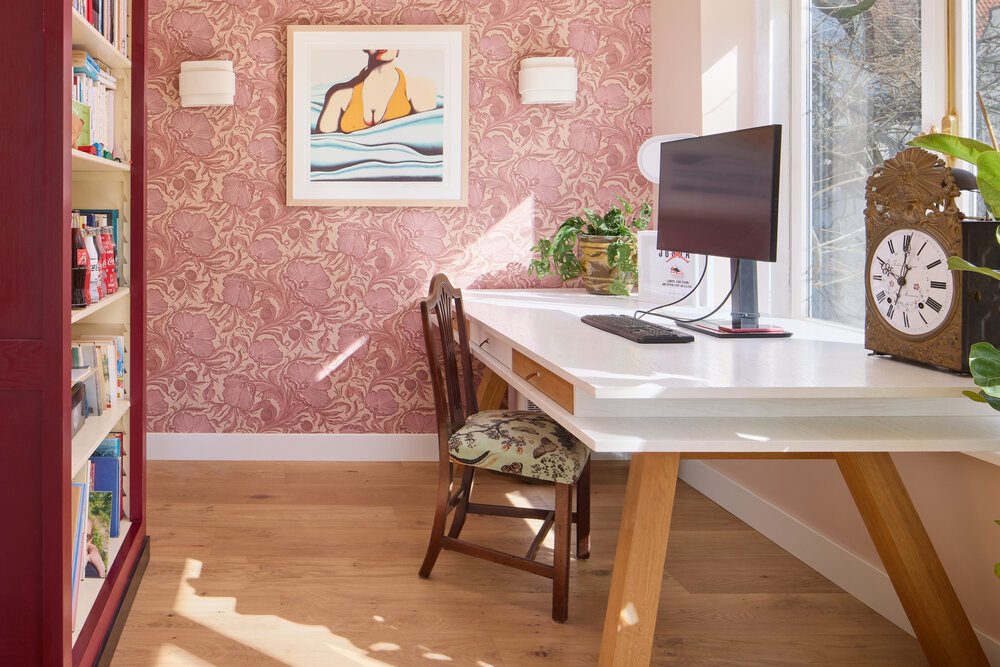 Interior photograph of the home office featuring oak plank flooring.