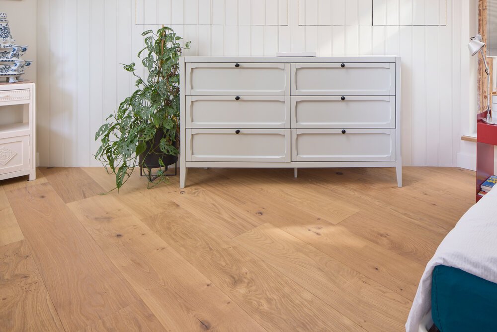 The slanted wall in this room creates a distinctive result with the plank flooring.