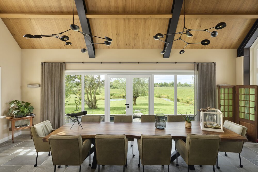 Open-plan kitchen with unobstructed views and a warm atmosphere, despite the micro-perforated acoustic roof panels.