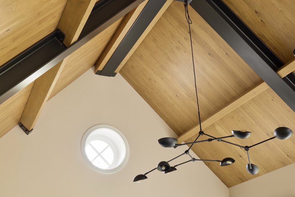 Keeping the steel structure exposed adds character to the open-plan kitchen.
