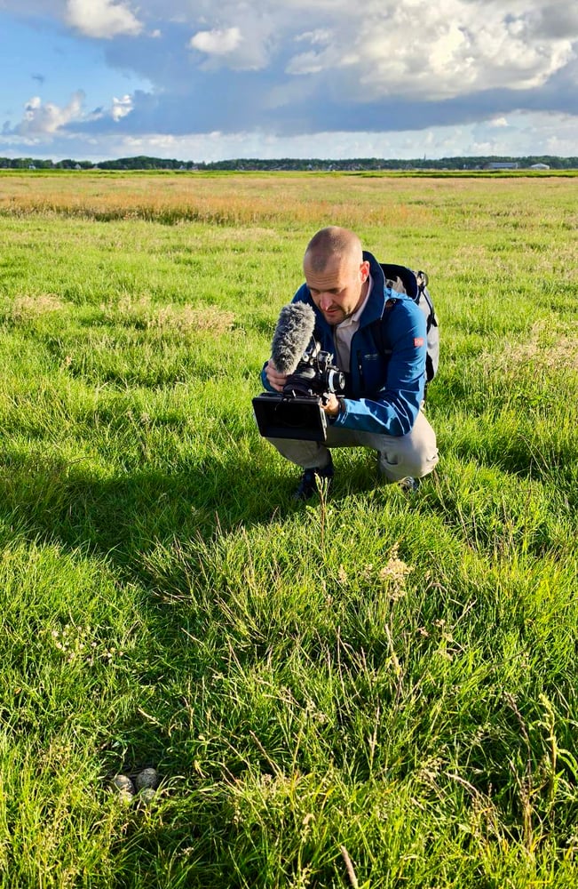 Foto van mij tijdens het filmen in het veld.